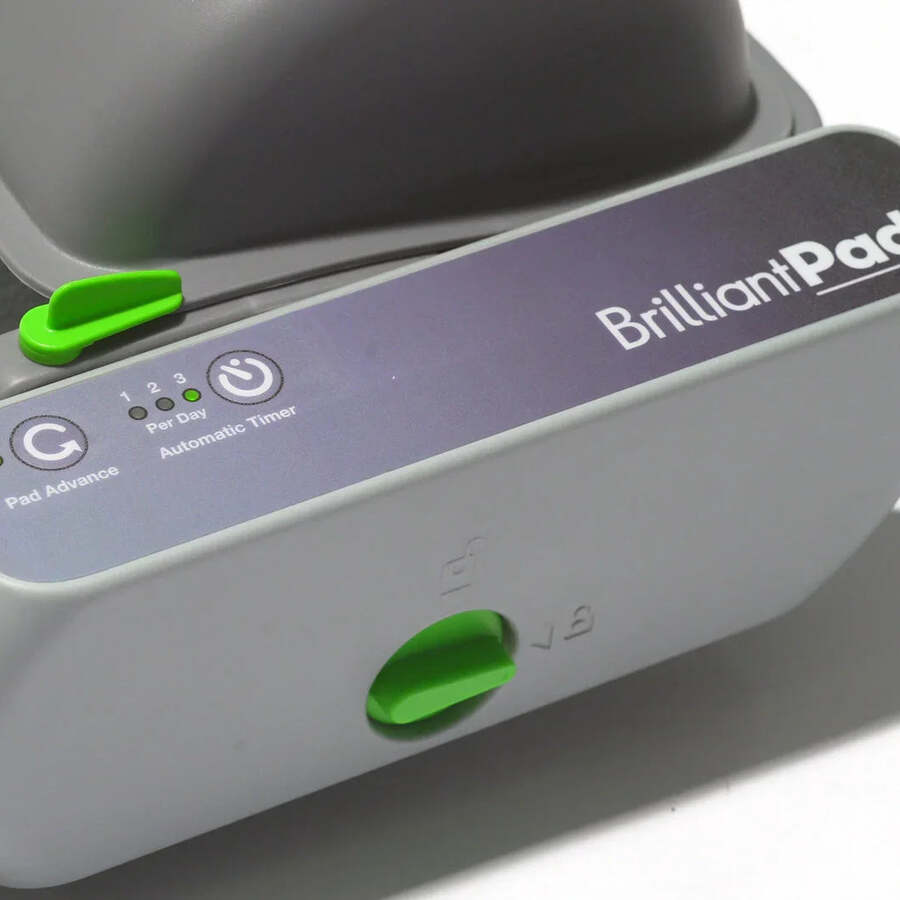 Close-up of the BrilliantPad Smart control module: pad advance button and automatic timer