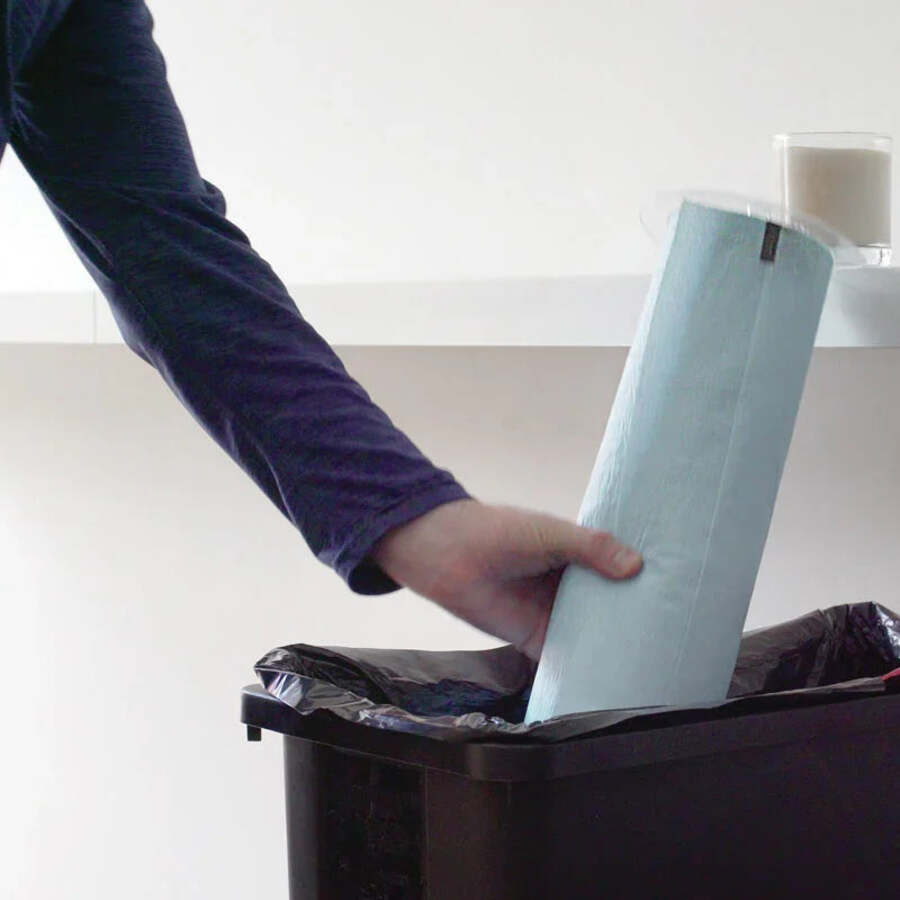 Sealed used roll being thrown into a bin, without odour or contact